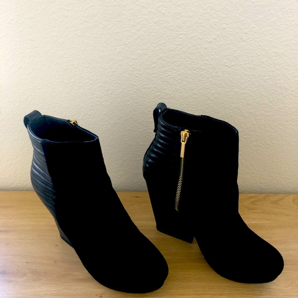 Black booties with gold zipper